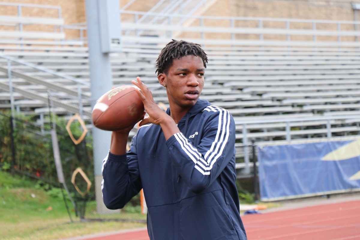 Student throwing a football.