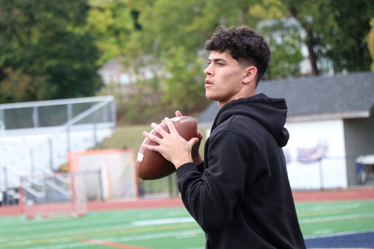 Student throwing a football.