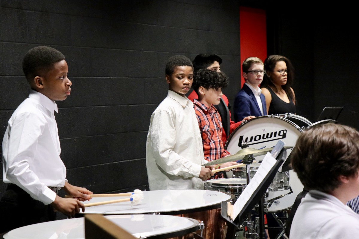 Students play percussion instruments