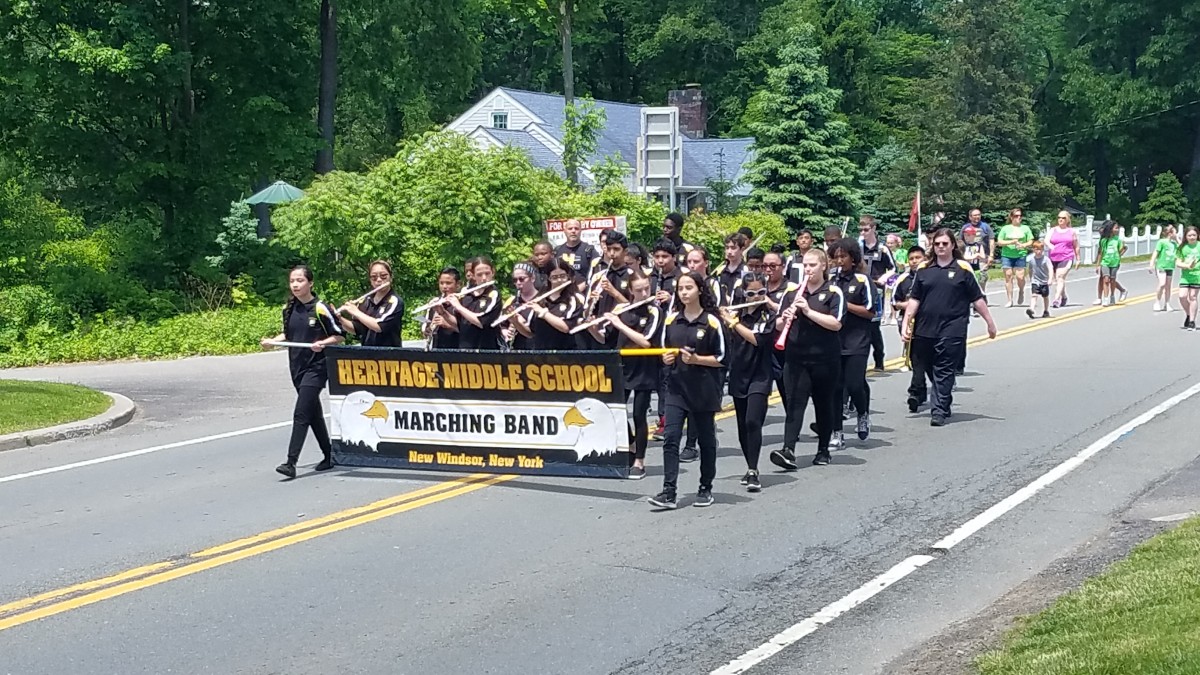 Students marching with banner.