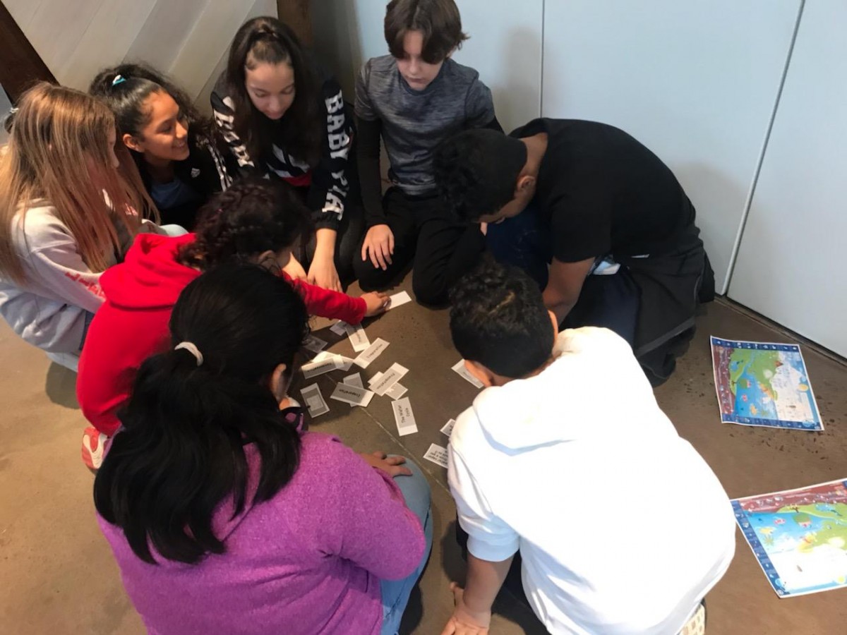 Scholars learn at a table.