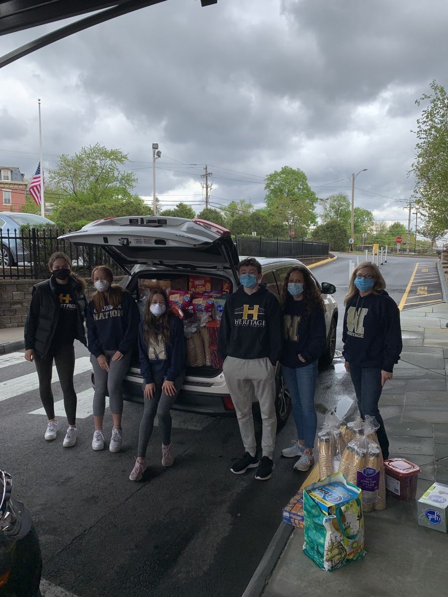 Heritage Middle School volunteers pose with donated items outside the hospital.