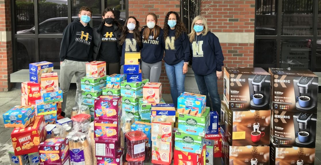 Heritage Middle School volunteers pose with donated items outside the hospital.