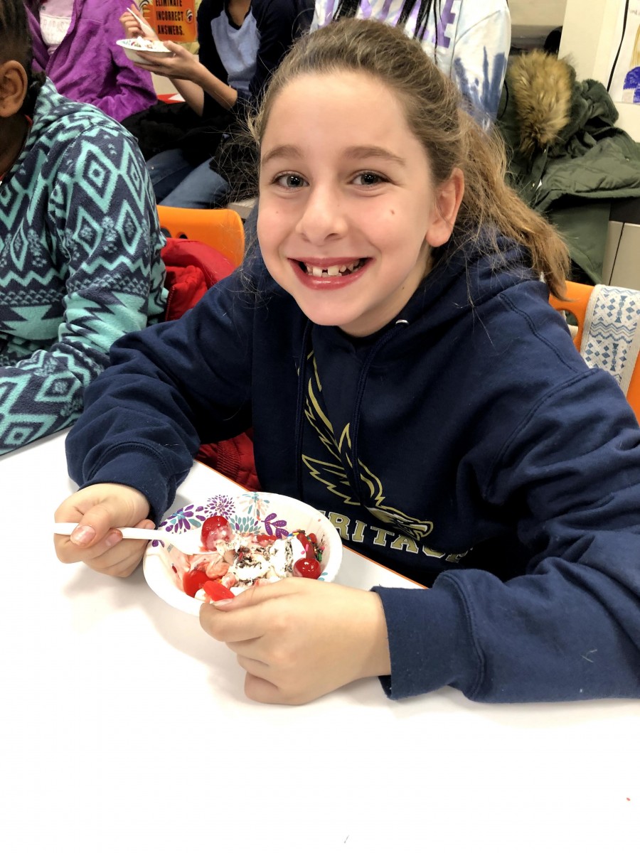 Student enjoying ice cream sundae.