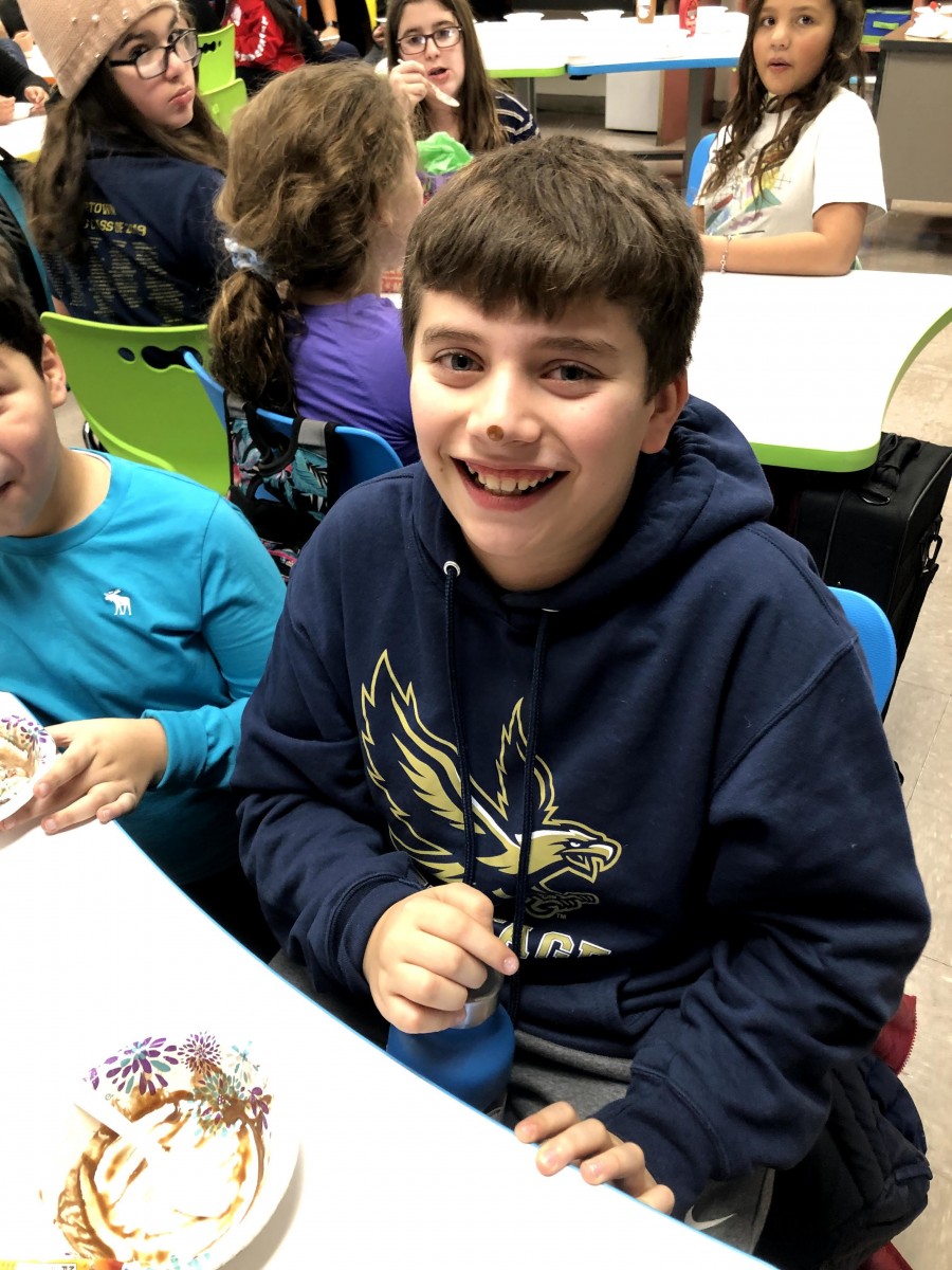 Student enjoying ice cream sundae.