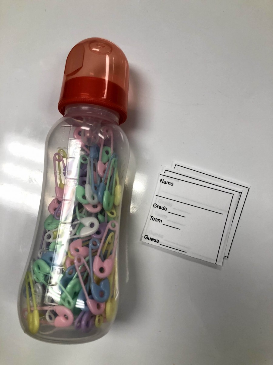 Bottle filled with safety pins for guessing game.