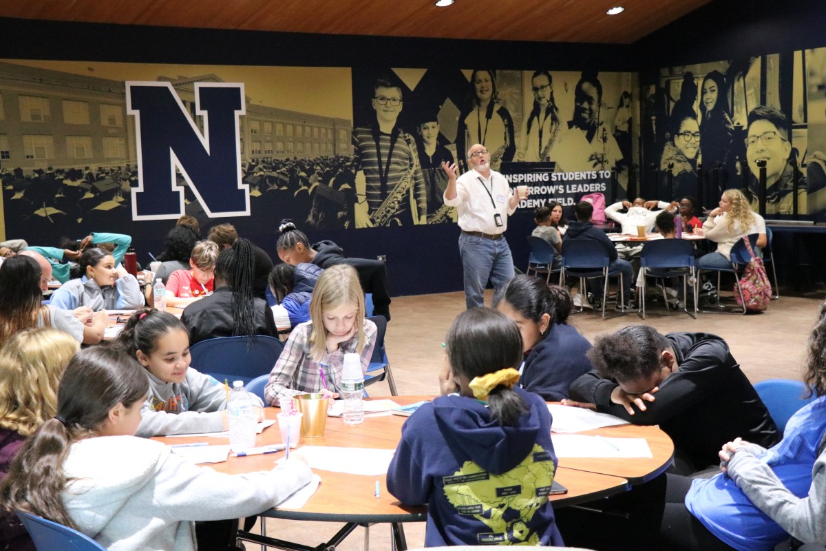 Students listen to a presentation.