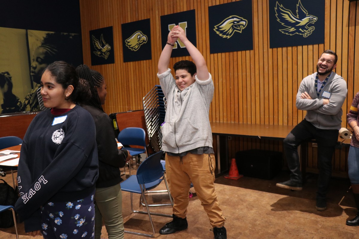 Students participate in a game called Telephone Charades.