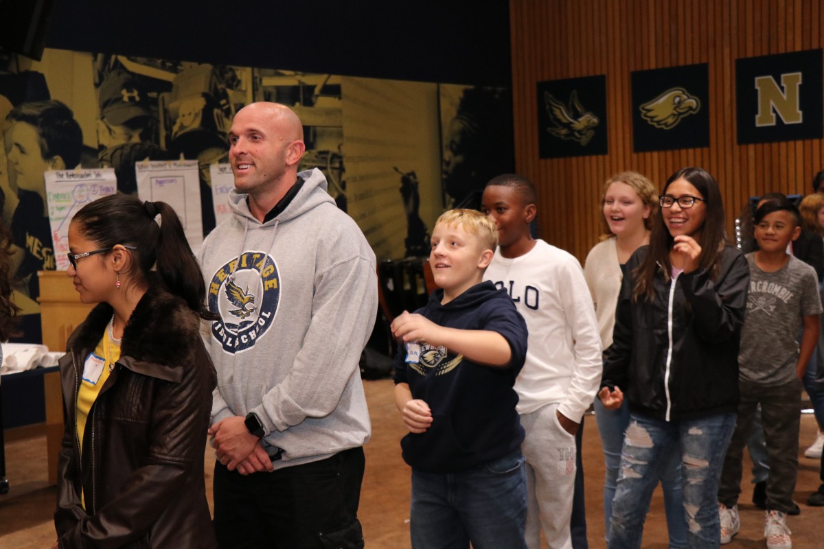 Students participate in a game called Telephone Charades.