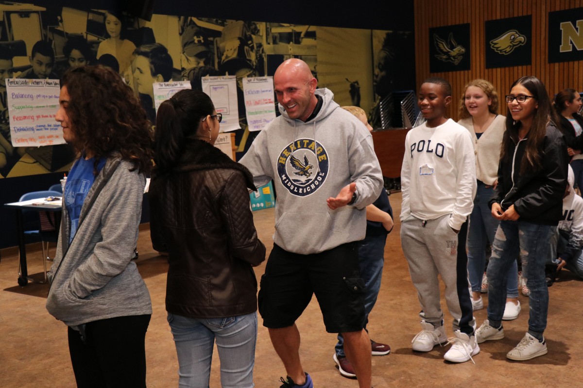 Students participate in a game called Telephone Charades.