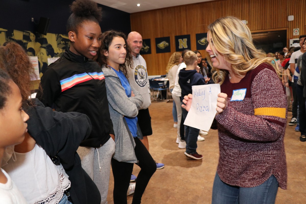 Students participate in a game called Telephone Charades.