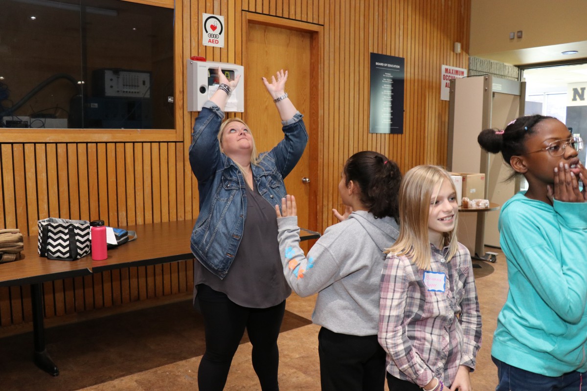 Students participate in a game called Telephone Charades.