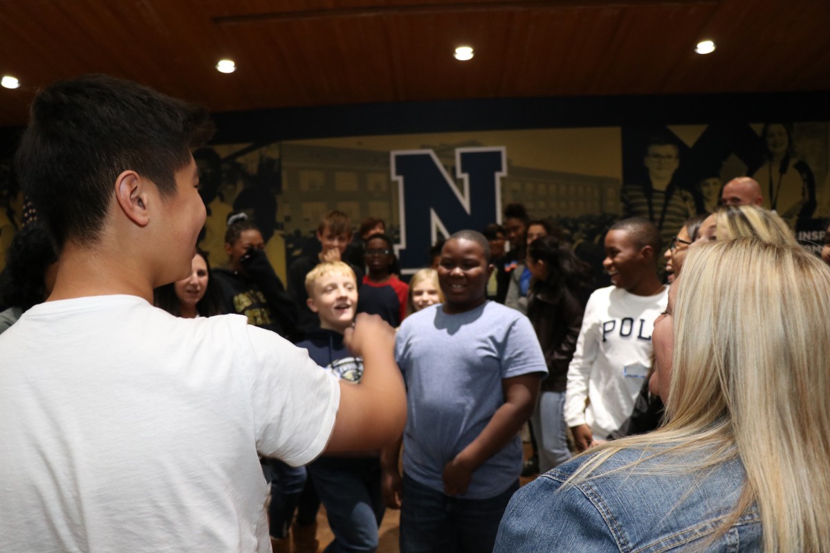 Students participate in a game called Telephone Charades.