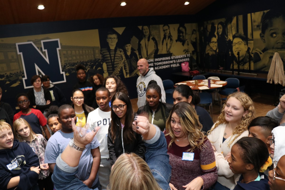 Students participate in a game called Telephone Charades.