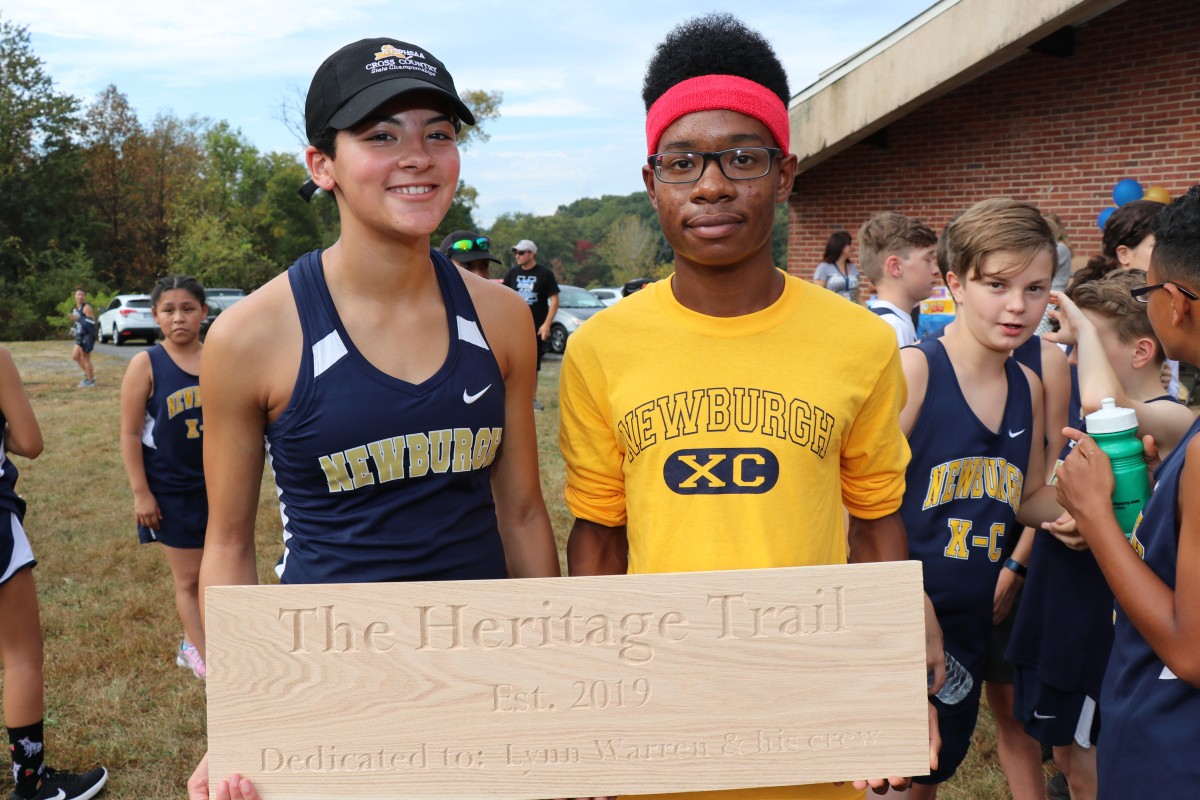 Speakers stand with a plaque.