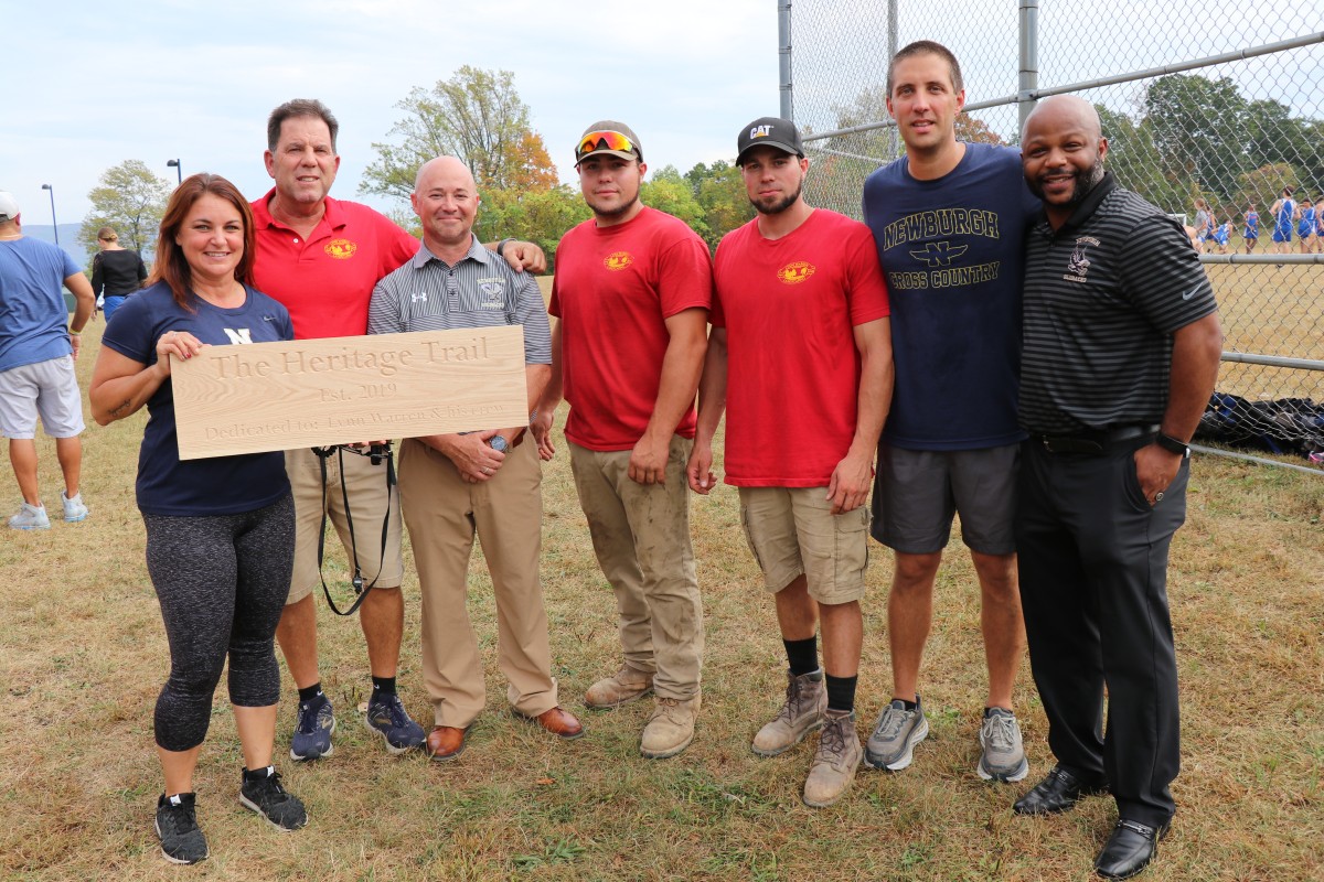 Lynn Warren stands with workers, Coaches Workman and Marino, Athletic Director Edgar Glascott and Director of Physical Education Howie Harrison.