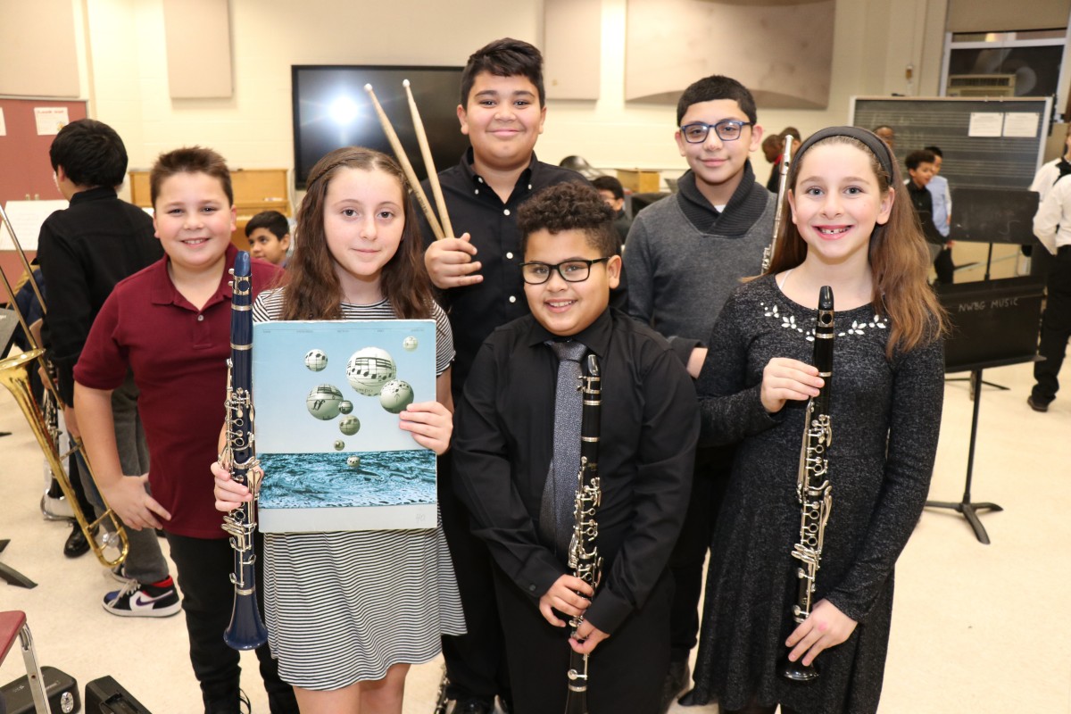 Students pose for a photo with their instruments.