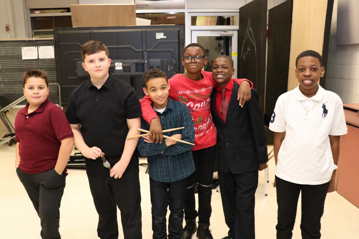 Students pose for a photo with their instruments.