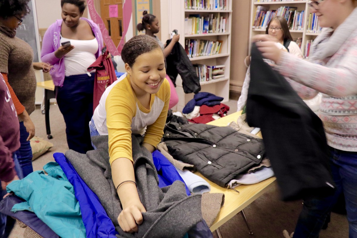 Students sort coats and prepare for transport