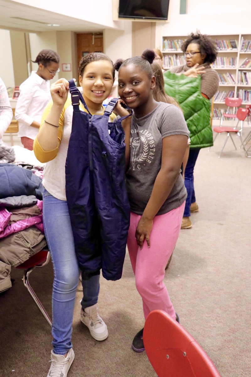 Students sort coats and prepare for transport