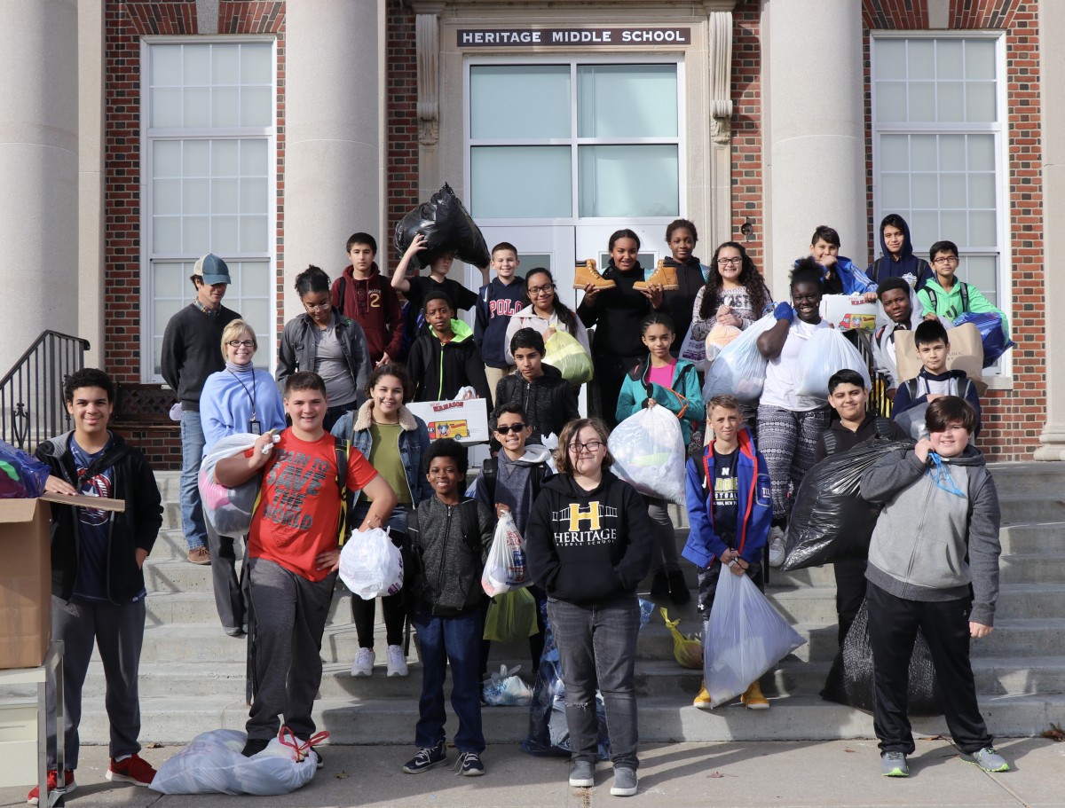 Students from project H.O.P..E pose with their donations