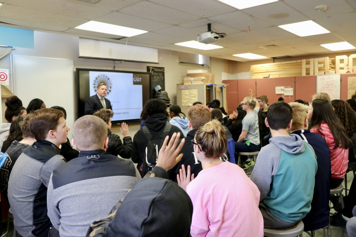 Agent speaks to class