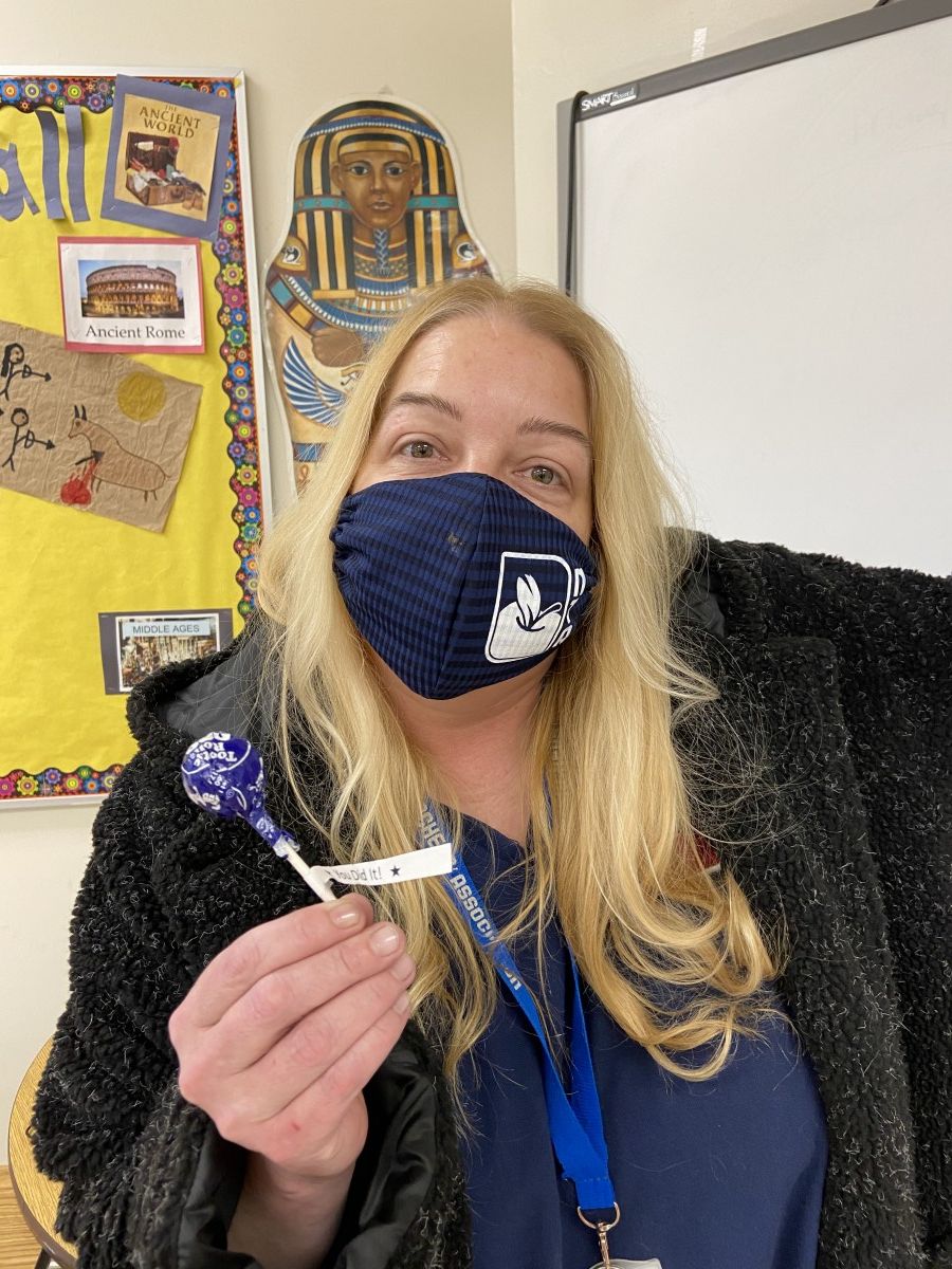Ms. Jen Laudiero poses for a photo with her lollipop after getting her COVID-19 test.
