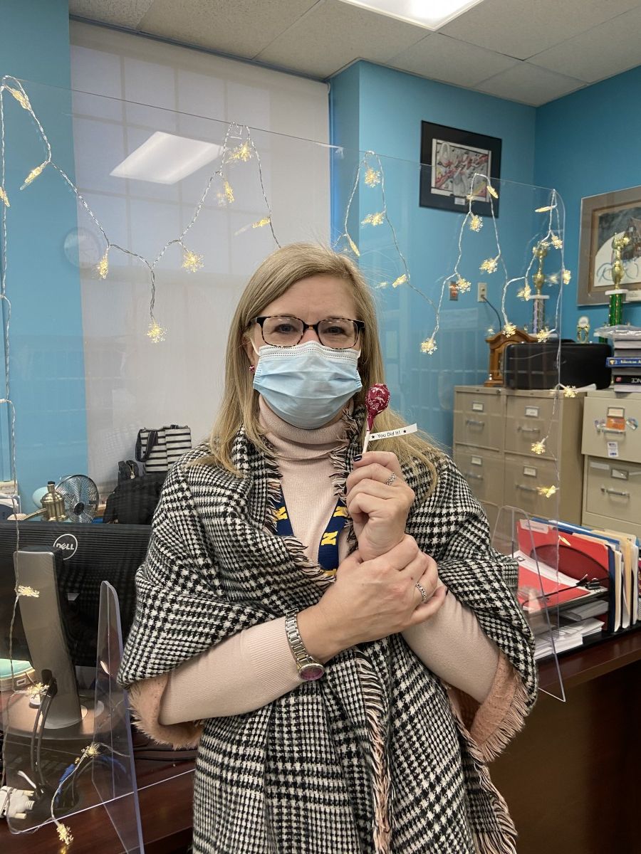 Ms. Brunger poses for a photo with her lollipop after getting her COVID-19 test.