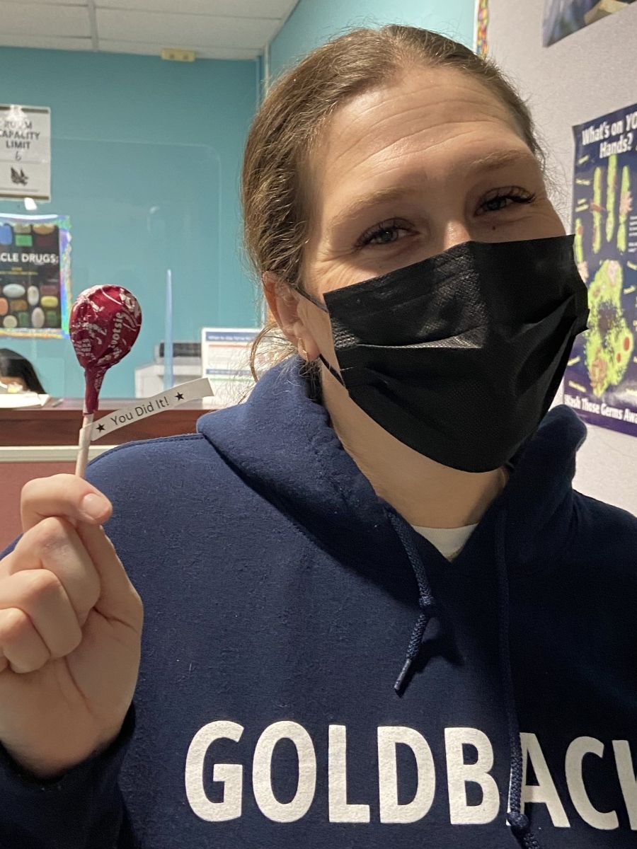 Ms. Layne poses for a photo with her lollipop after getting her COVID-19 test.