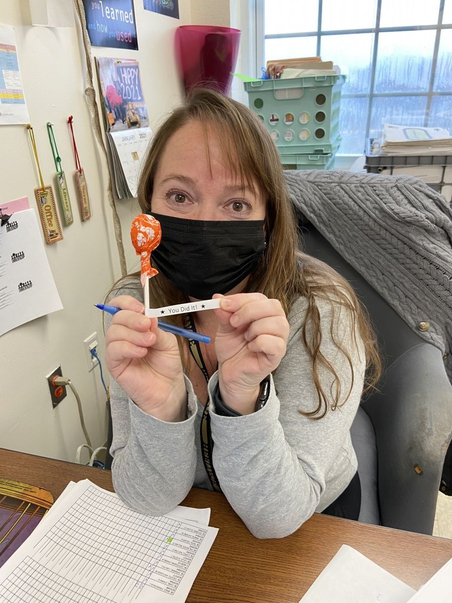 Ms. Cat Crofton poses for a photo with her lollipop after getting her COVID-19 test.
