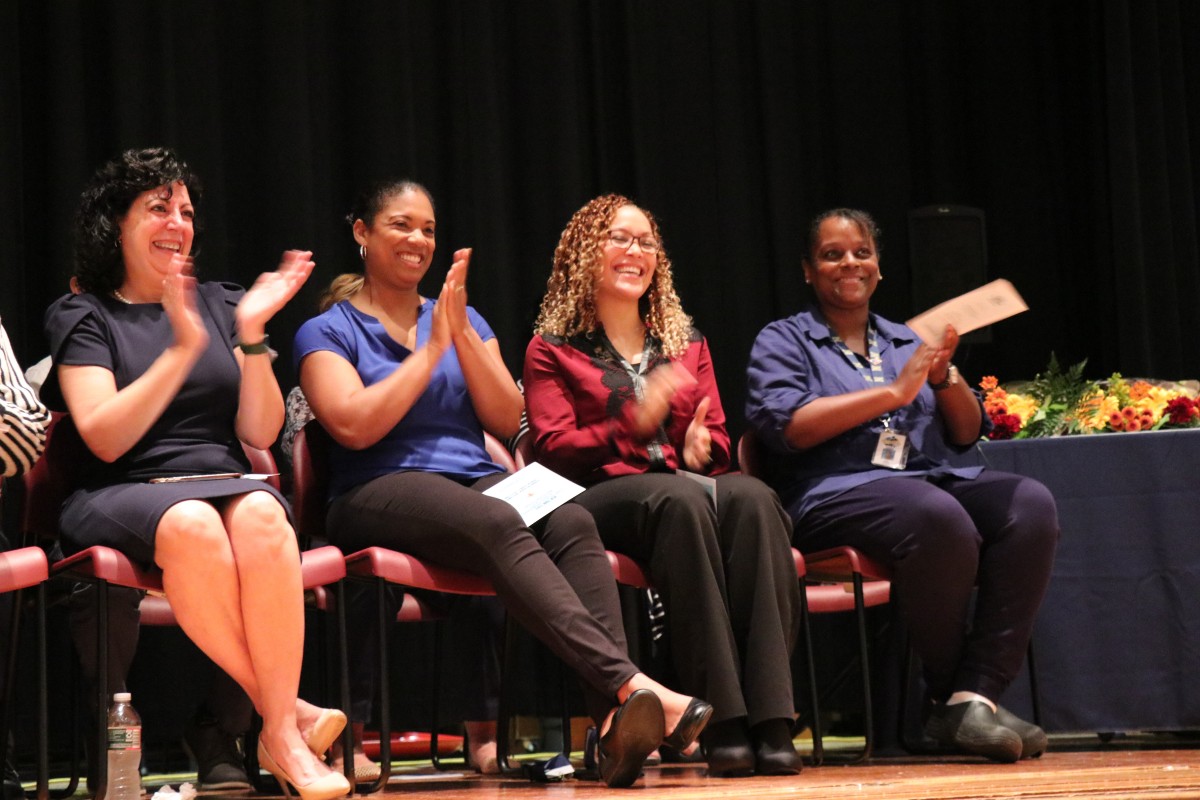 Teachers applaud their students.