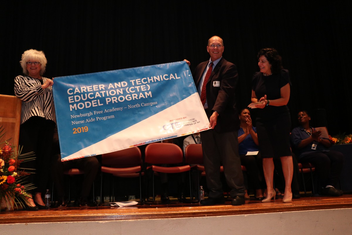 Representatives from CTE TAC present the award.