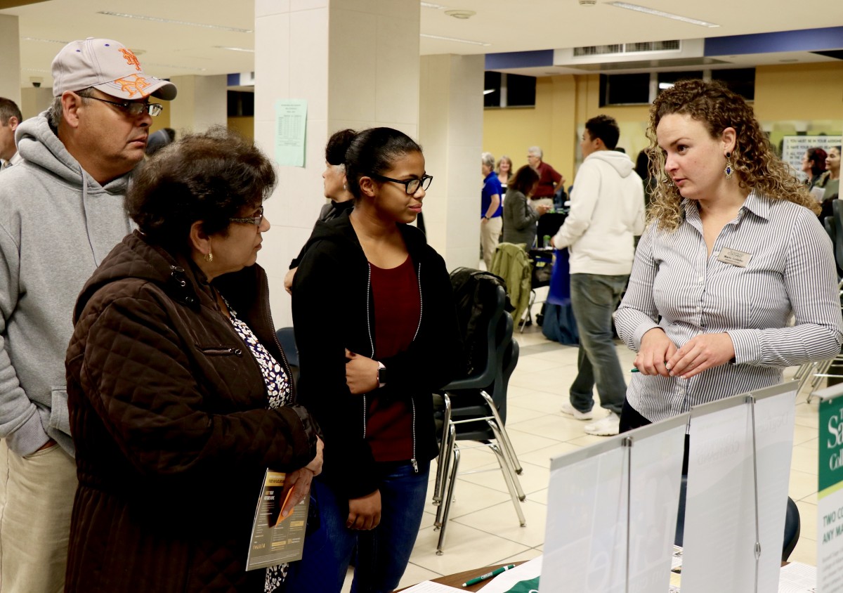 Students and parents speak with college admissions representative