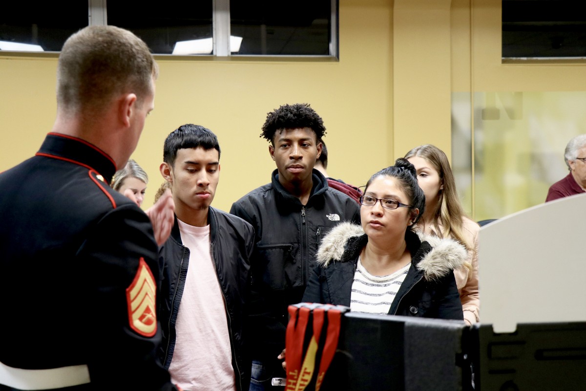 Students and parents speak with recruitment representative