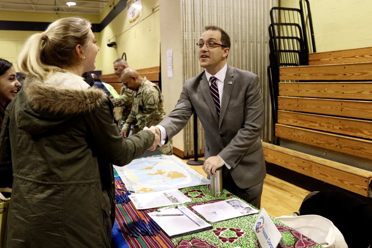 Students and parents speak with Peace Corps representative