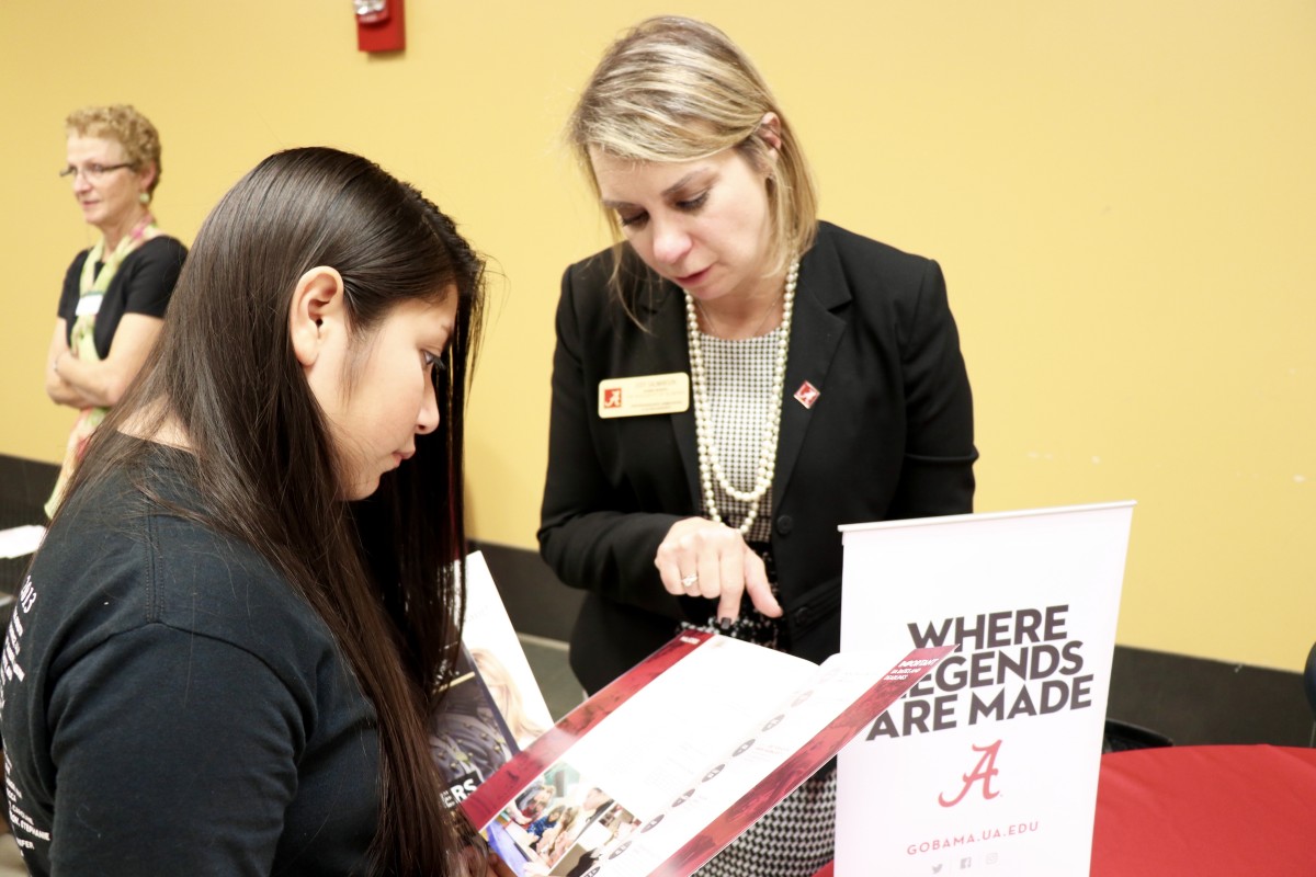 Students and parents speak with college admissions representative