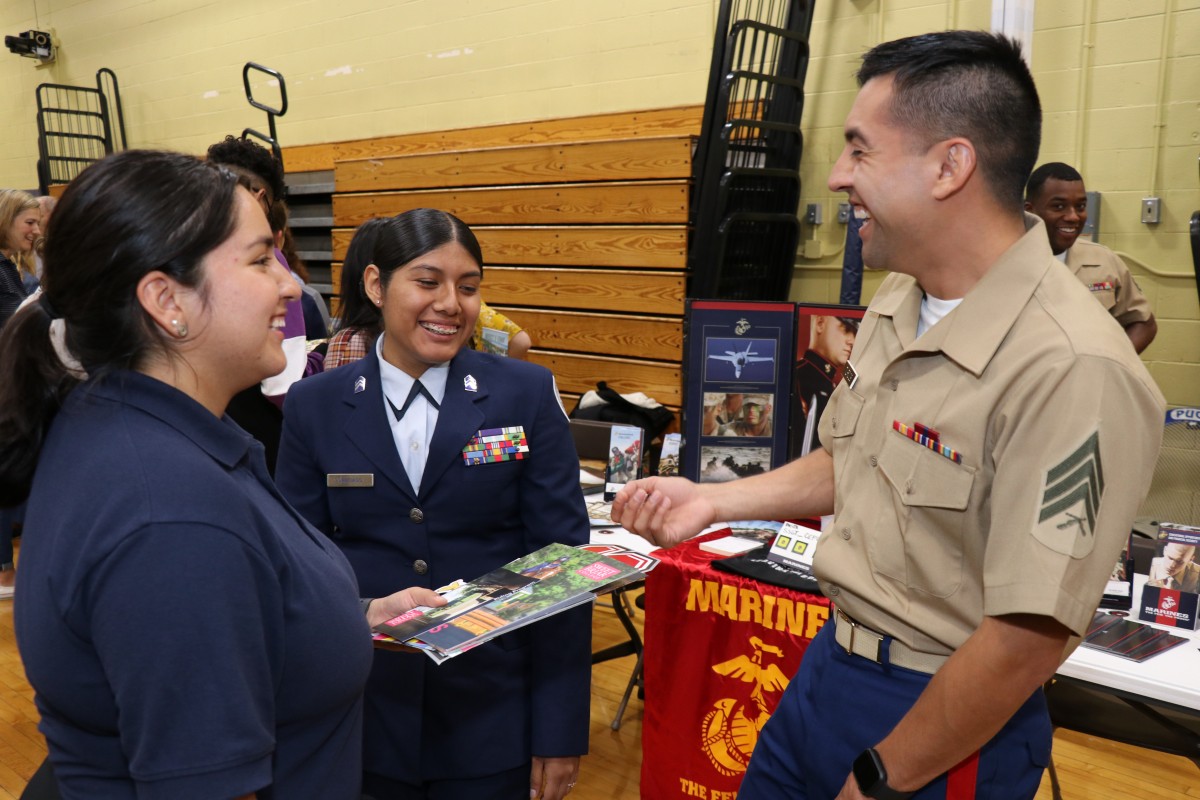 Attendees speak with college admission staff.