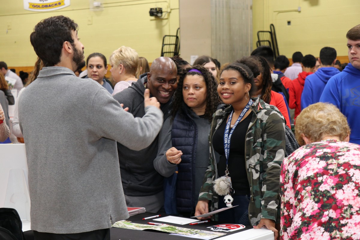 Attendees speak with college admission staff.