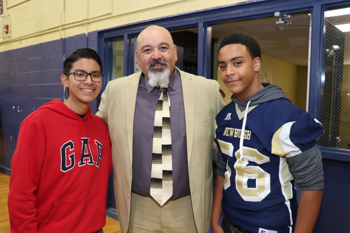 Students pose for a photo with principal, Mr. Raul Rodriguez.