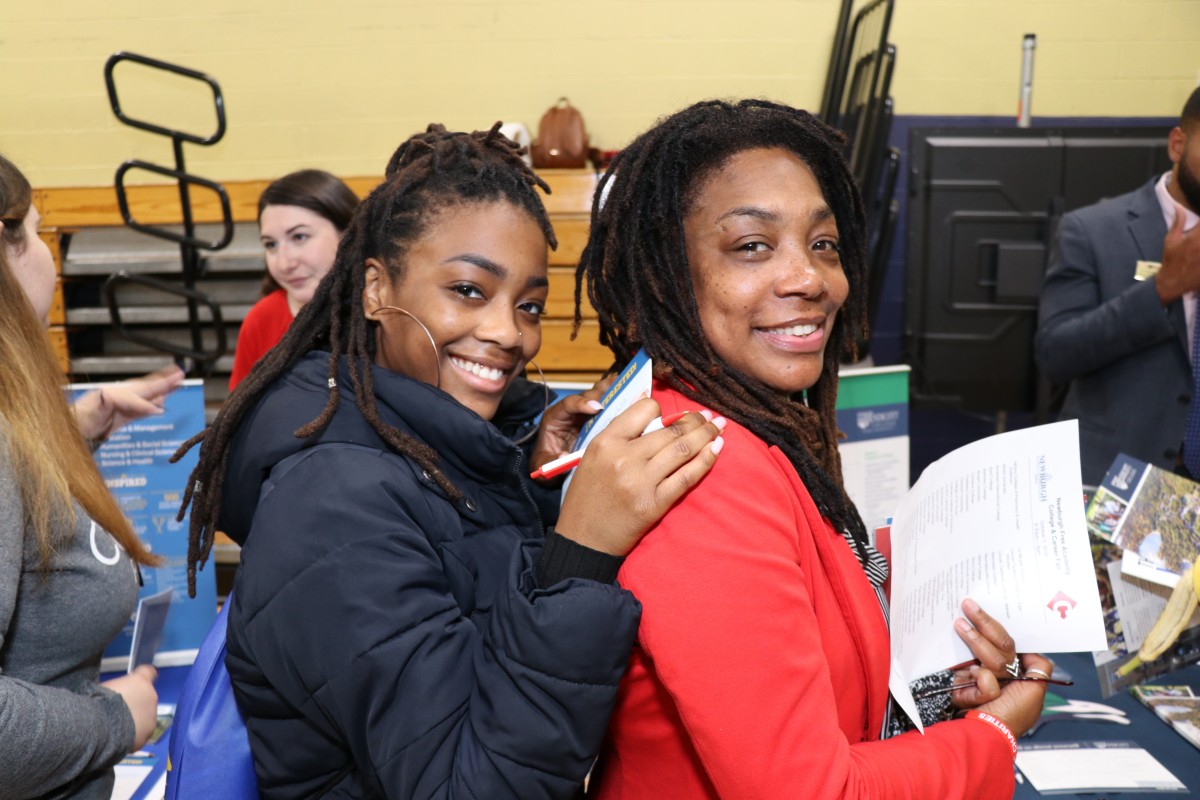 Student fills out form with assistance.