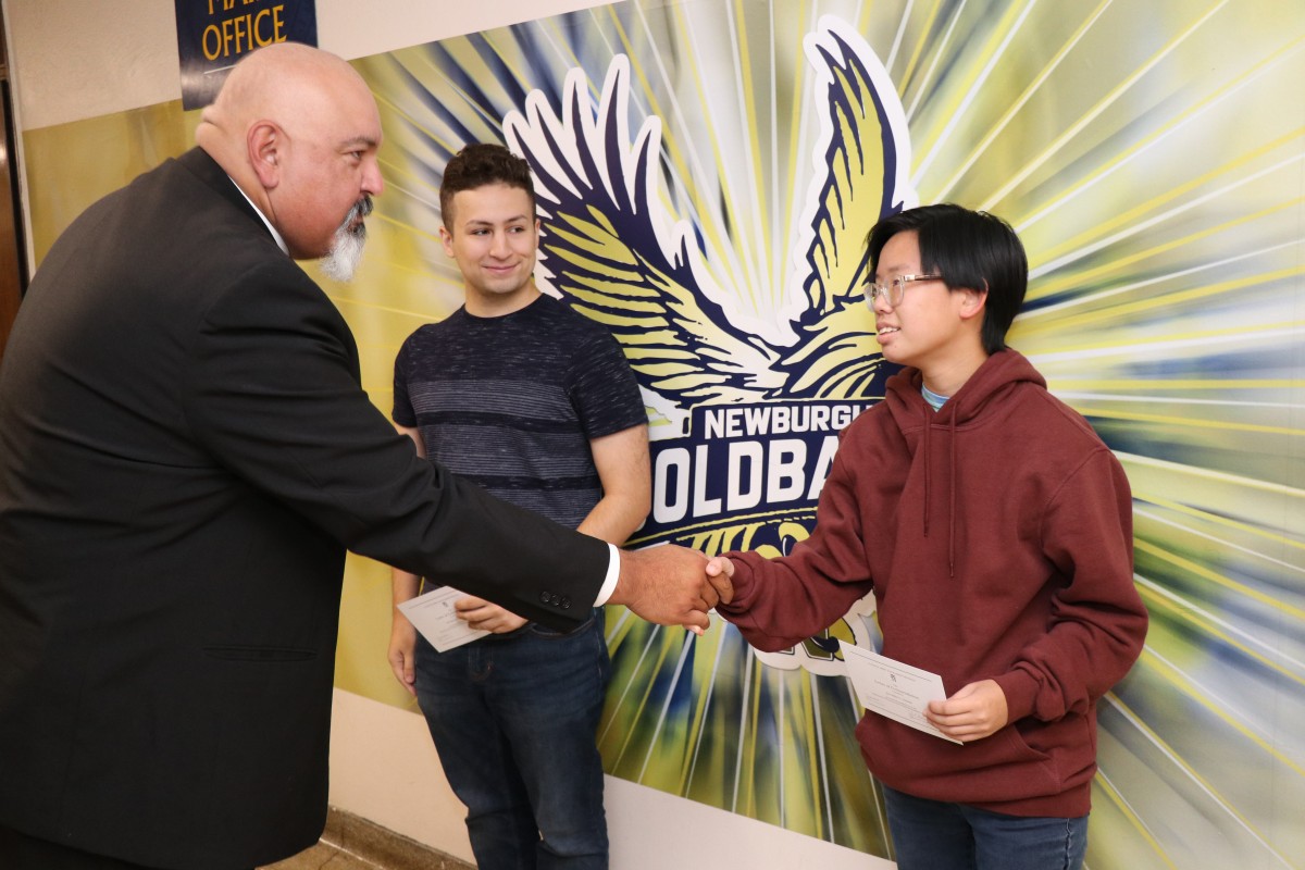 Principal, Mr. Raul Rodriguez congratulates recipient.