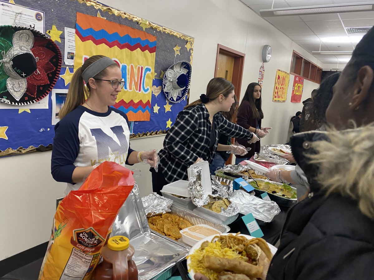 NFA Key Club members serve food to their guest.