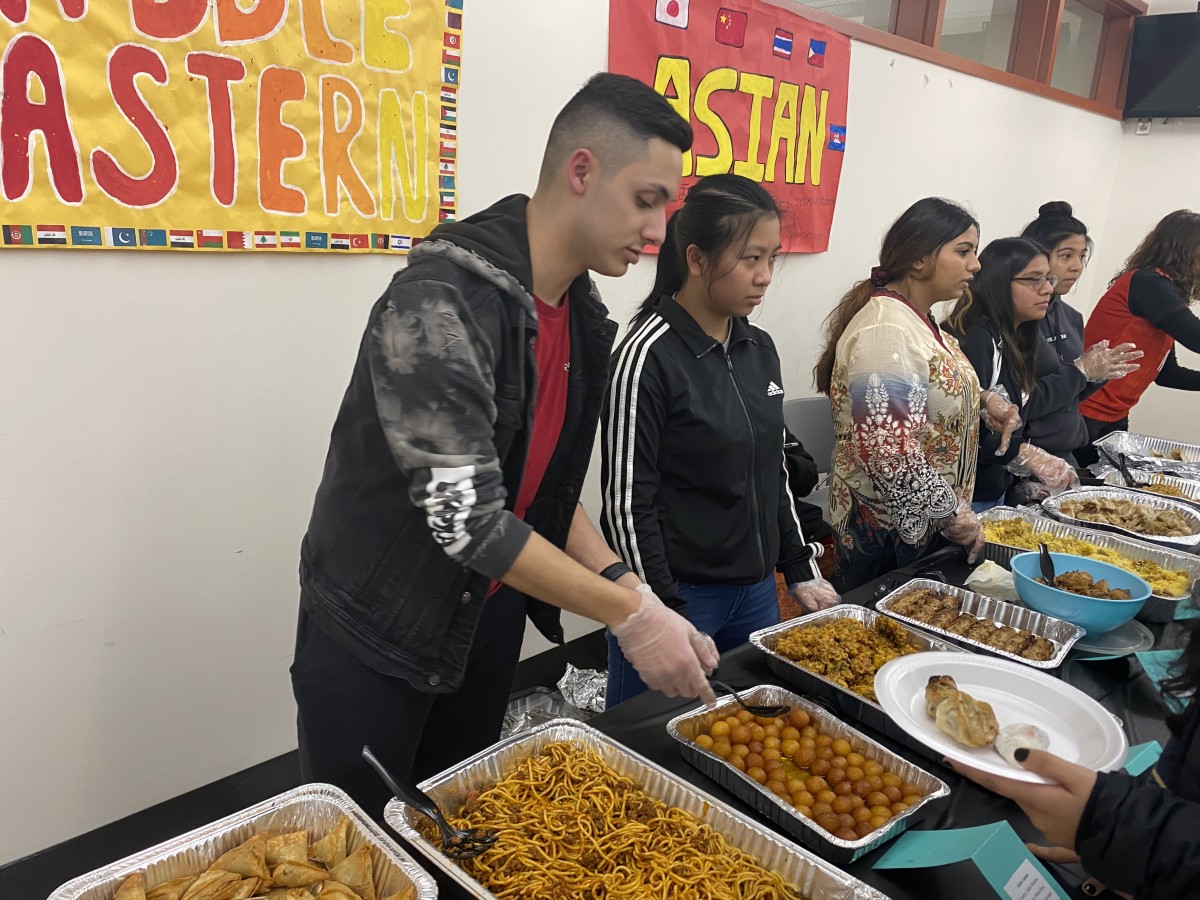 NFA Key Club members serve food to their guest.