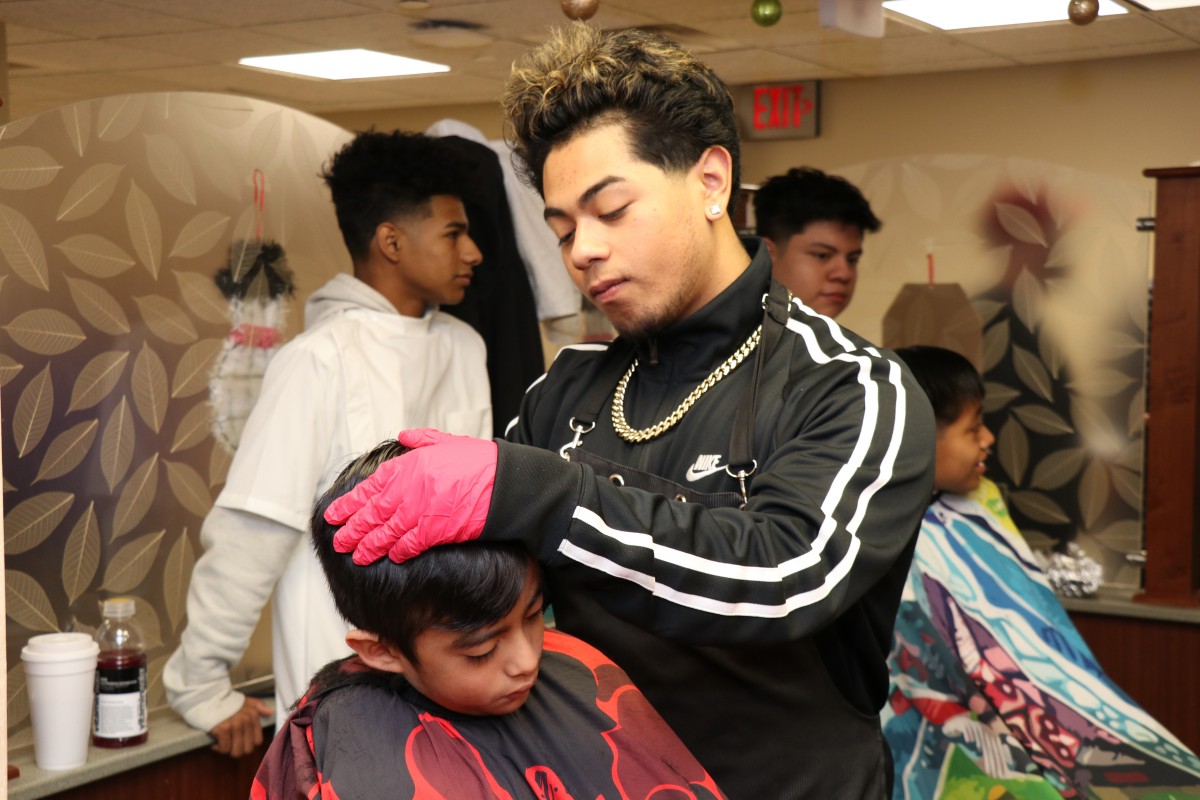 Student cutting hair.