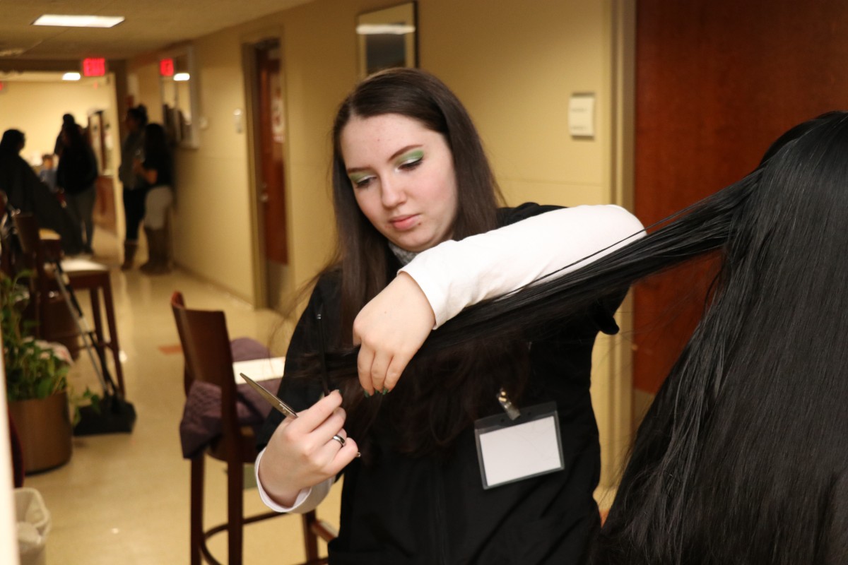 Student cutting hair.