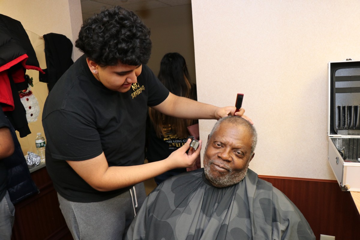 Student cutting hair.