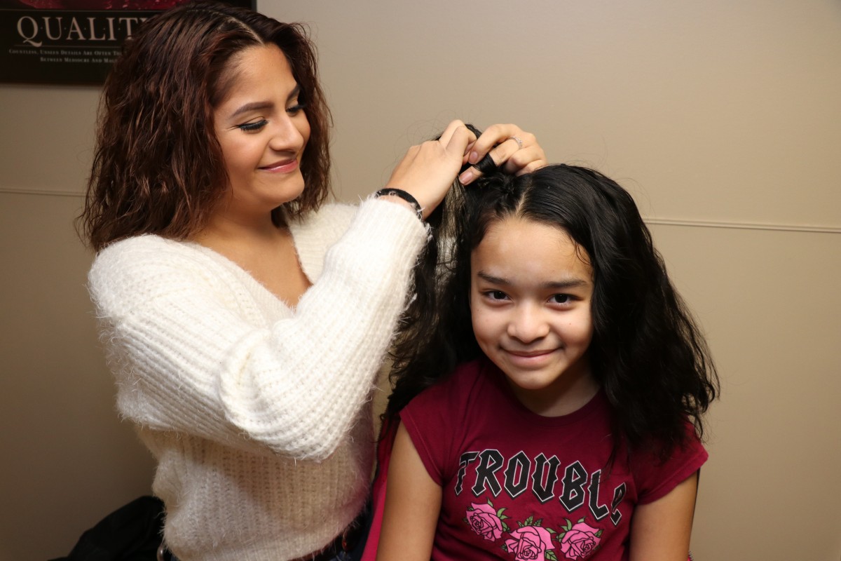 Student cutting hair.