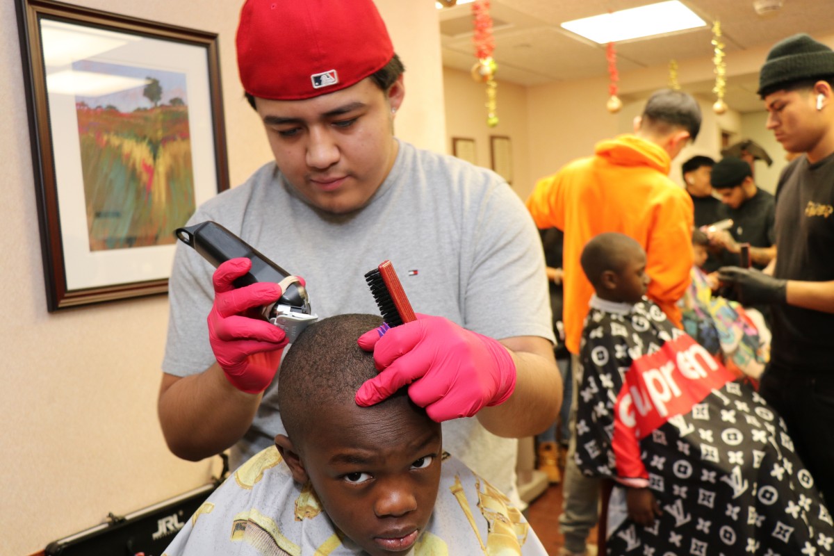 Student cutting hair.