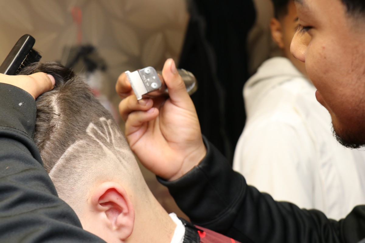 Student cutting hair.