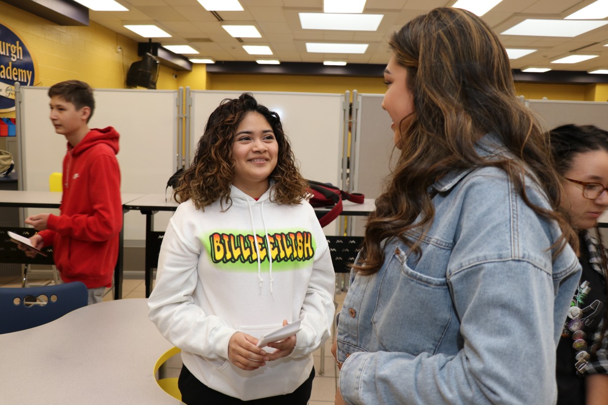 Students chatting as they meet their mentor.